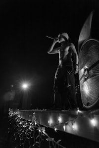 a man is standing on a platform with lights